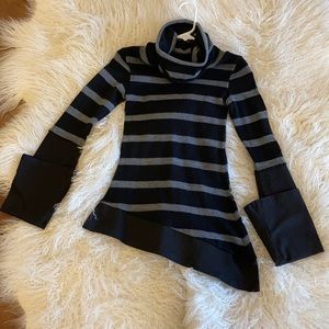 Striped asymmetrical fitted turtle neck sweater.
